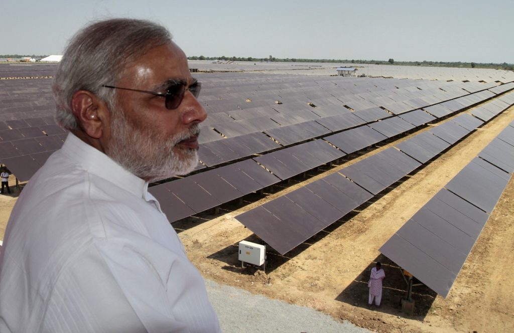 Gujarat state Chief Minister Narendra Modi overlooks the panels at a newly inaugurated solar energy farm at Gunthawada in Gujarat state, about 175 kilometers (109 miles) north of Ahmadabad, India, Friday, Oct. 14, 2011. The 30 mega-watt solar farm built by Moser has been set up with an investment of Rupees 4.65 billion (US $96,875,000) and uses 236,000 thin film modules, according to an official release. (AP Photo/Ajit Solanki)